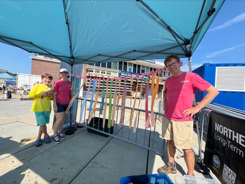 Team members shared research under a tent.