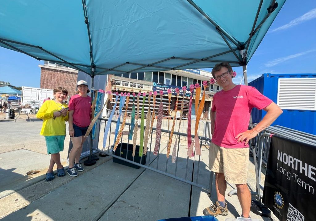 Team members shared research under a tent.